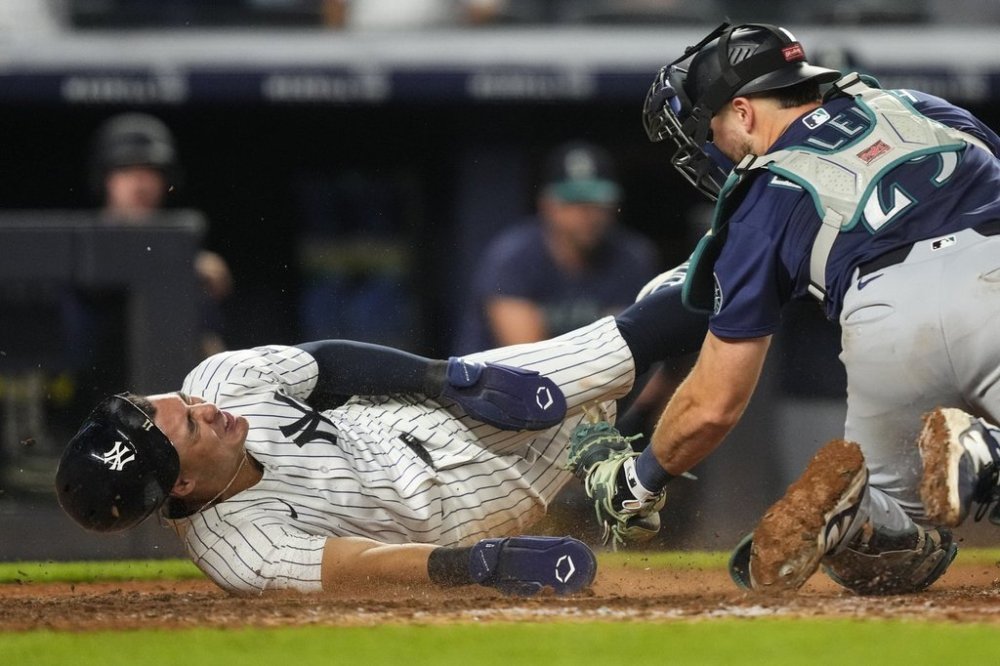 New York Yankees' Anthony Volpe (11) slides into home base during the 10th inning of a baseball game against the Seattle Mariners, Thursday, July 10, 2025, in New York. (AP Photo/Yuki Iwamura)