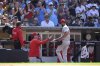 Philadelphia Phillies starter Cristopher Sanchez, front right, is greeted at the dugout after a pitching change in the eighth inning of a baseball game against the San Diego Padres, Sunday, July 13, 2025, in San Diego. (AP Photo/Orlando Ramirez)