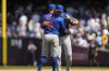 Chicago Cubs infielders Jon Berti (5) and Michael Busch celebrate after defeating the New York Yankees in a baseball game, Saturday, July 12, 2025, in New York. (AP Photo/Yuki Iwamura)