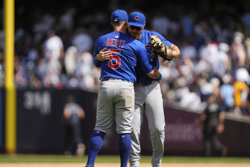 Chicago Cubs infielders Jon Berti (5) and Michael Busch celebrate after defeating the New York Yankees in a baseball game, Saturday, July 12, 2025, in New York. (AP Photo/Yuki Iwamura)