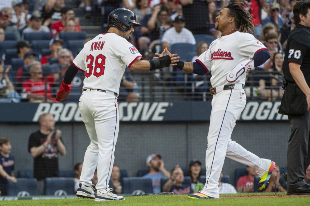 Cleveland Guardians' Steven Kwan (38) congratulates Jose Ramirez, right, after they scored on a single by Kyle Manzardo during the fourth inning of a baseball game against the Baltimore Orioles, Wednesday, July 23, 2025, in Cleveland. (AP Photo/Phil Long)