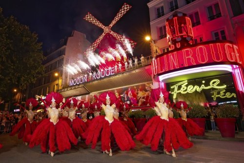 Dancers perform outside the Moulin Rouge cabaret to mark the mill's huge sails return to operation, Thursday July 10, 2025. (Moulin Rouge via AP)