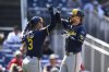 Milwaukee Brewers' Brice Turang, right, celebrates after his two-run home run with Joey Ortiz, left, during the seventh inning of a baseball game against the Washington Nationals, Sunday, Aug. 3, 2025, in Washington. (AP Photo/Nick Wass)