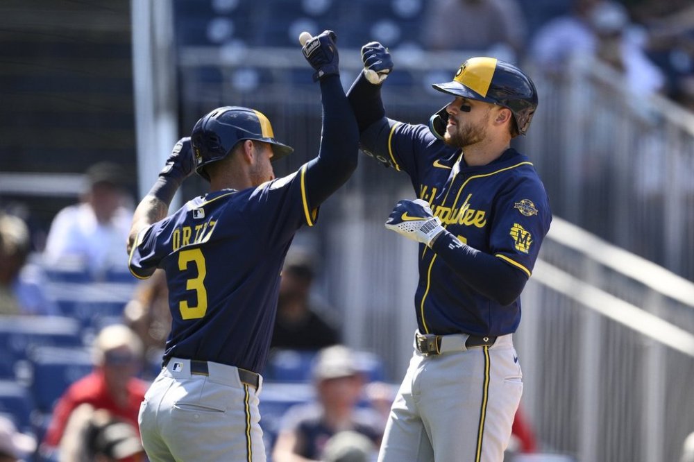 Milwaukee Brewers' Brice Turang, right, celebrates after his two-run home run with Joey Ortiz, left, during the seventh inning of a baseball game against the Washington Nationals, Sunday, Aug. 3, 2025, in Washington. (AP Photo/Nick Wass)