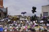 Floral tributes left at the Black Sabbath Bridge bench on Broad Street in memory of Black Sabbath frontman Ozzy Osbourne ahead of the funeral procession, in Birmingham, England, Wednesday July 30, 2025. (Joe Giddens/PA via AP)
