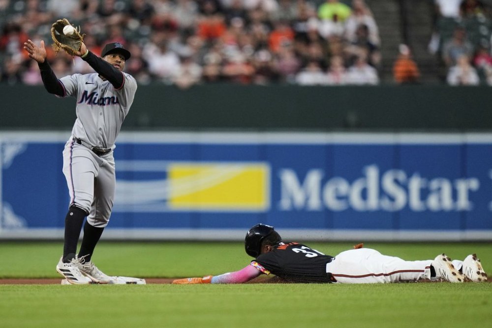 Baltimore Orioles' Cedric Mullins, right, steals second base in front of Miami Marlins second baseman Xavier Edwards, left, during the fourth inning of a baseball game, Friday, July 11, 2025, in Baltimore. (AP Photo/Stephanie Scarbrough)