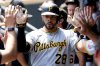 Pittsburgh Pirates' Tommy Pham celebrates in the dugout after hitting a single home run during the second inning of a baseball game against the Minnesota Twins Sunday, July 13, 2025, in Minneapolis. (AP Photo/Ellen Schmidt)