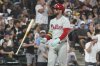 Philadelphia Phillies' Bryce Harper flips his bat as he pops out to Chicago White Sox third baseman Colson Montgomery in foul territory during the seventh inning of a baseball game in Chicago, Monday, July 28, 2025. (AP Photo/Nam Y. Huh)