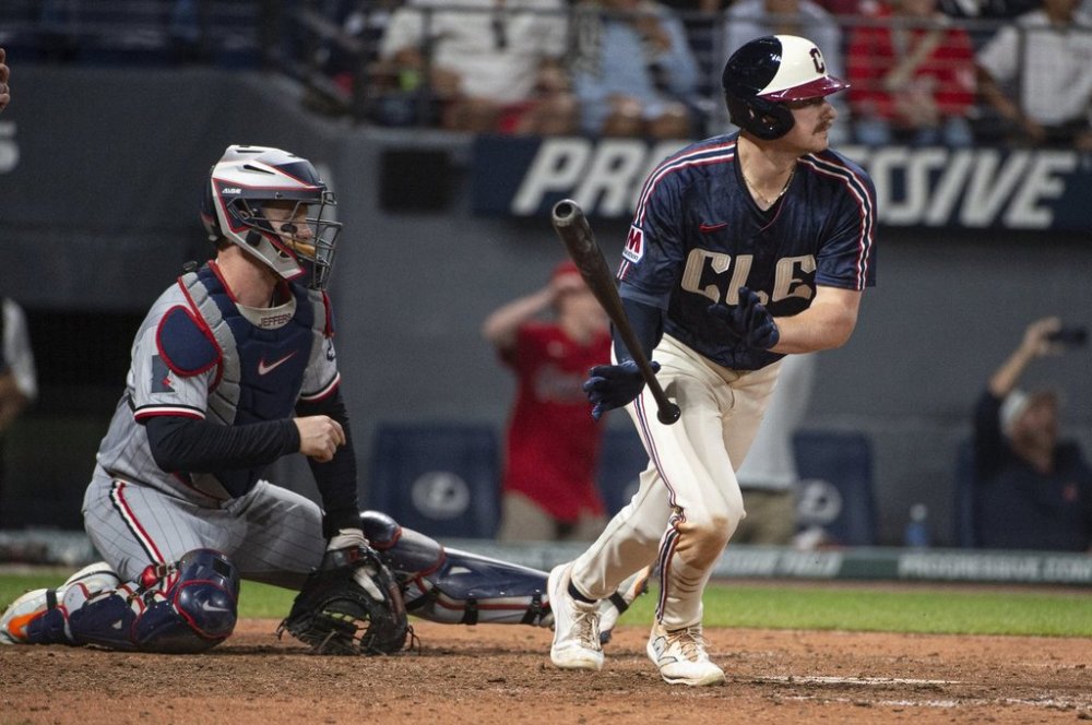 Cleveland Guardians' Kyle Manzardo, right, watches his winning RBI single off Minnesota Twins relief pitcher Kody Fundereburk during the 10th inning of a baseball game, Friday, Aug. 1, 2025, in Cleveland. (AP Photo/Phil Long)