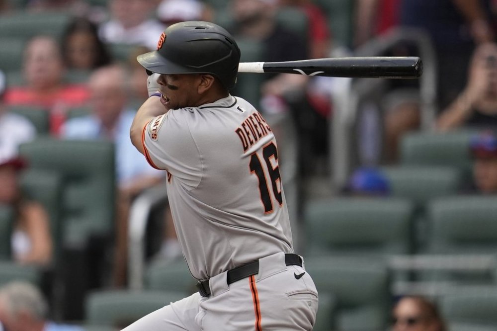 San Francisco Giants designated hitter Rafael Devers (16) hits a single against the Atlanta Braves in the first inning of a baseball game, Monday, July 21, 2025, in Atlanta. (AP Photo/Mike Stewart)
