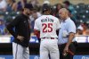 Minnesota Twins' Byron Buxton (25) is looked at by manager Rocco Baldelli (5), left, and a trainer after being hit by a pitch during the first inning of a baseball game against the Chicago Cubs Wednesday, July 9, 2025, in Minneapolis. (AP Photo/Abbie Parr)
