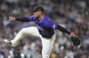 Colorado Rockies relief pitcher Tyler Kinley works against the Minnesota Twins in the eighth inning of a baseball game Saturday, July 19, 2025, in Denver. (AP Photo/David Zalubowski)