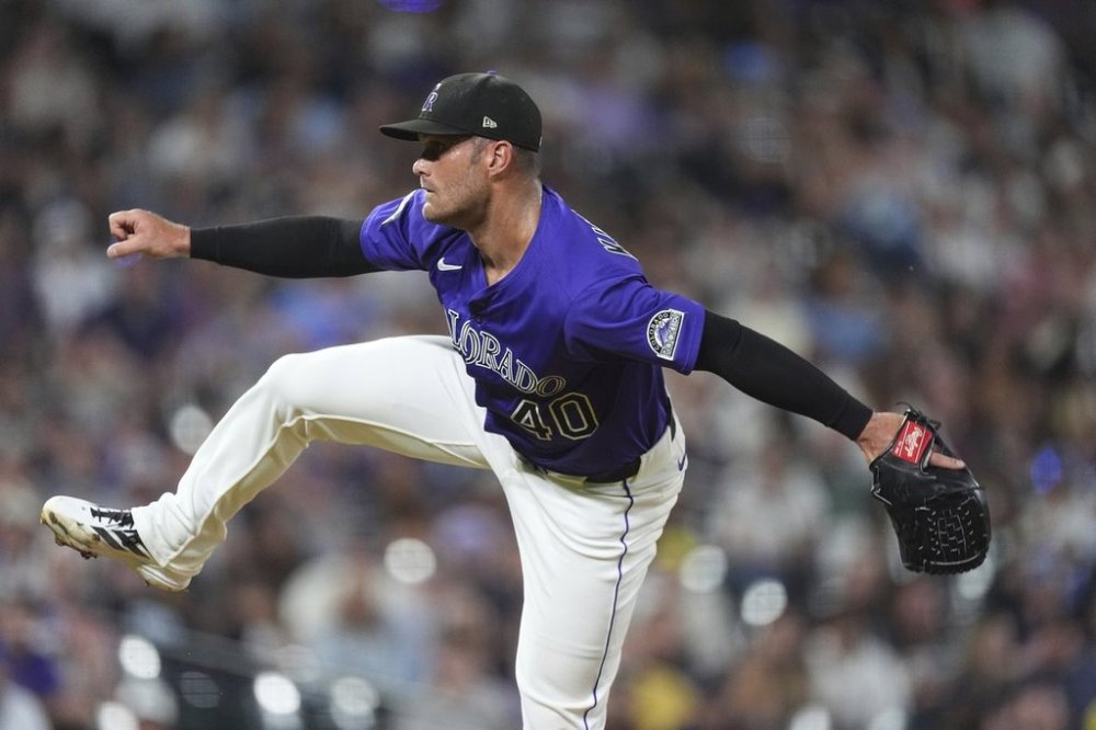 Colorado Rockies relief pitcher Tyler Kinley works against the Minnesota Twins in the eighth inning of a baseball game Saturday, July 19, 2025, in Denver. (AP Photo/David Zalubowski)