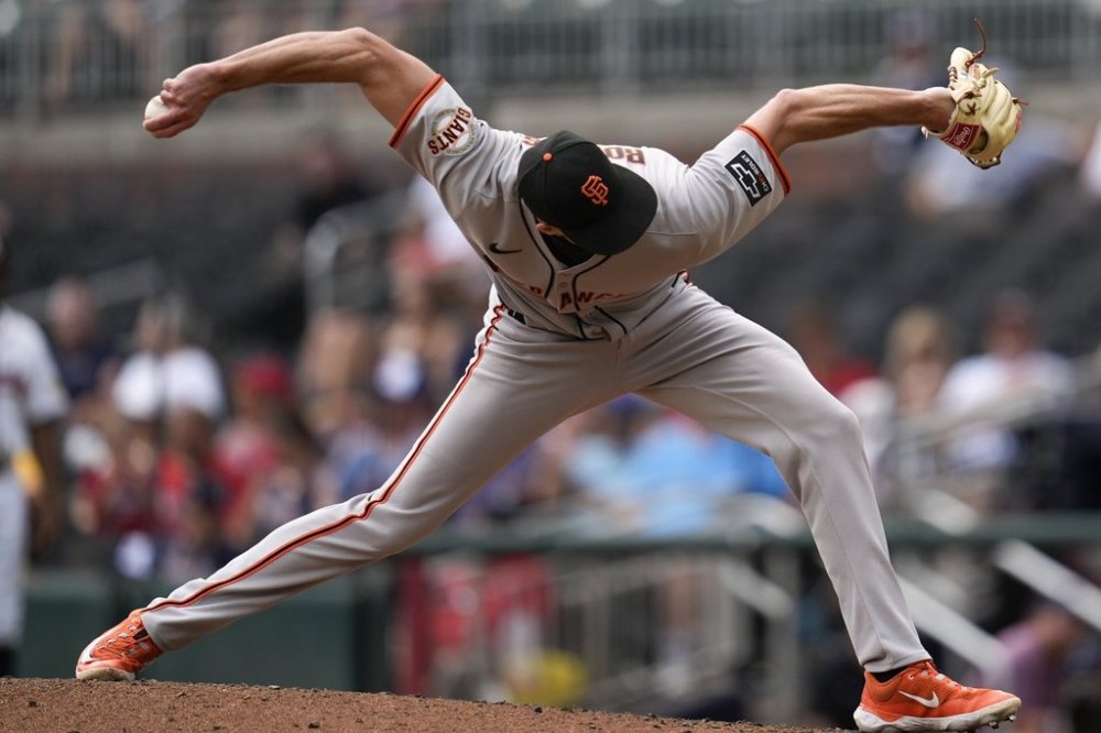 San Francisco Giants pitcher Tyler Rogers (71) delivers in the ninth inning of a baseball game against the Atlanta Braves, Wednesday, July 23, 2025, in Atlanta. (AP Photo/Mike Stewart)