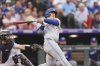 Toronto Blue Jays' Daulton Varsho hits a two-run home run off Colorado Rockies starting pitcher Anthony Molina in the fourth inning of a baseball game Tuesday, Aug. 5, 2025, in Denver. (AP Photo/David Zalubowski)
