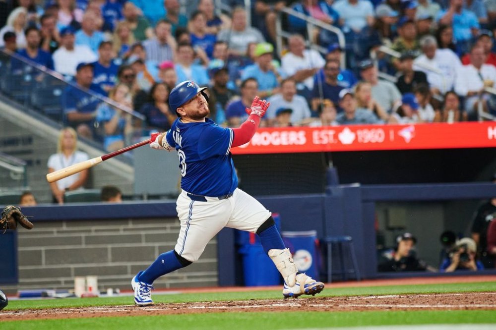 Toronto Blue Jays catcher Alejandro Kirk (30) throws his bat as he runs to first base during seventh inning MLB baseball action in Toronto, on Wednesday, July 2, 2025. THE CANADIAN PRESS/Sammy Kogan