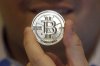 FILE - In this April 3, 2013 photo, a 25 Bitcoin token is displayed in Sandy, Utah. (AP Photo/Rick Bowmer, File)