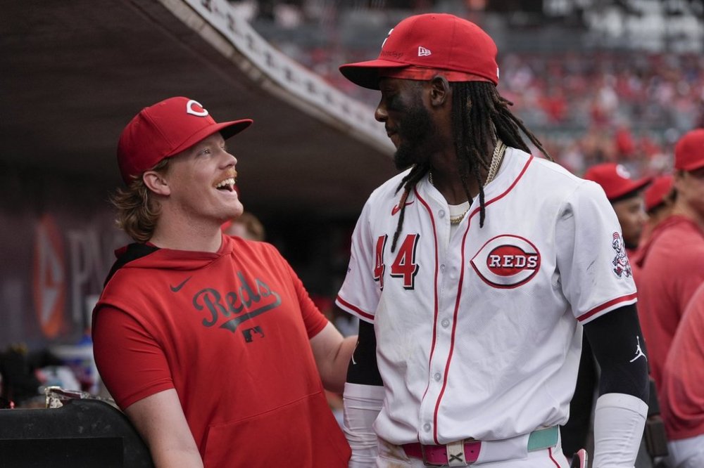 Cincinnati Reds pitcher Andrew Abbott, left, and shortstop Elly De La Cruz celebrate in the dugout as it was announced that Abbott will join De La Cruz as the Reds' representatives for the 2025 Major League Baseball All-Star Game, during the fourth inning of a baseball game against the Miami Marlins in Cincinnati, Tuesday, July 8, 2025. (AP Photo/Carolyn Kaster)