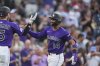 Colorado Rockies' Hunter Goodman, left, congratulates Ezequiel Tovar as he crosses home plate after hitting a two-run home run off Minnesota Twins relief pitcher Brock Stewart in the fifth inning of a baseball game Saturday, July 19, 2025, in Denver. (AP Photo/David Zalubowski)