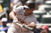 San Francisco Giants designated hitter Rafael Devers (16) attepts a bunt in the eighth inning of a baseball game against the Atlanta Braves, Wednesday, July 23, 2025, in Atlanta. (AP Photo/Mike Stewart)