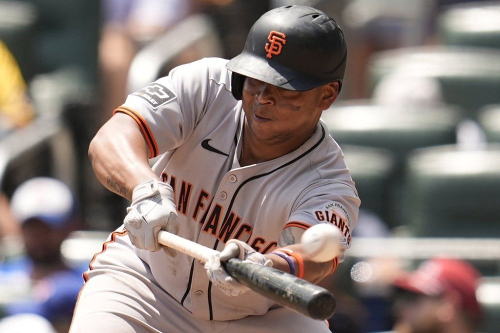 San Francisco Giants designated hitter Rafael Devers (16) attepts a bunt in the eighth inning of a baseball game against the Atlanta Braves, Wednesday, July 23, 2025, in Atlanta. (AP Photo/Mike Stewart)