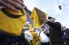 Rory McIlroy of Northern Ireland signs autographs on the 18th green watched by the new Spidercam, top right, following a practice round for the British Open golf championship at the Royal Portrush Golf Club, Northern Ireland, Tuesday, July 15, 2025. (AP Photo/Jon Super)