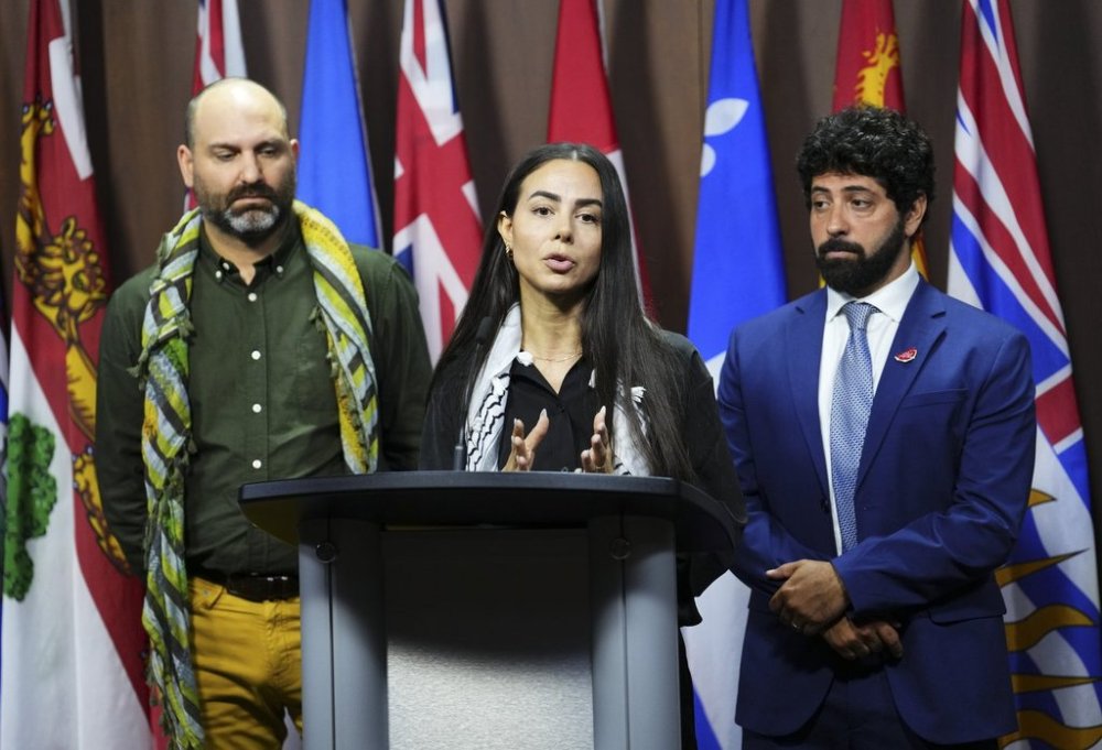 Yara Shoufani of Palestinian Youth Movement speaks alongside Alex Paterson with Canadians for Justice and Peace in the Middle East, left, and Corey Balsam of Independent Jewish Voices during a press conference on Parliament Hill in Ottawa on Tuesday, July 29, 2025. THE CANADIAN PRESS/Sean Kilpatrick
