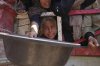 Palestinians struggle to get donated food at a community kitchen in Gaza City, northern Gaza Strip, on Saturday, July 26, 2025. (AP Photo/Abdel Kareem Hana)