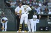 The Athletics trainer and manager Mark Kotsay, right, come to check on Athletics' Jacob Wilson (5) after he is hit by the pitch during the first inning of a baseball game against the Atlanta Braves, Tuesday, July 8, 2025, in West Sacramento, Calif. Wilson would go on to leave the game. (AP Photo/Scott Marshall)