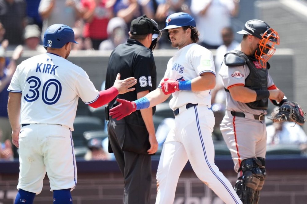 Toronto Blue Jays third base Addison Barger celebrates his two run home run with teammate catcher Alejandro Kirk (30) during fifth inning MLB action against the San Francisco Giants in Toronto on Sunday, July 20, 2025.  THE CANADIAN PRESS/Nathan Denette