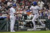 Texas Rangers' Marcus Semien, right, celebrates with third base coach Tony Beasley after hitting a home run against the Houston Astros during the eighth inning of a baseball game Sunday, July 13, 2025, in Houston. (AP Photo/David J. Phillip)