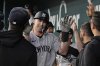New York Yankees' Paul Goldschmidt, center, celebrates with the team after hitting a solo home run in the seventh inning of a baseball game against the Texas Rangers Wednesday, Aug. 6, 2025, in Arlington, Texas. (AP Photo/Tony Gutierrez)