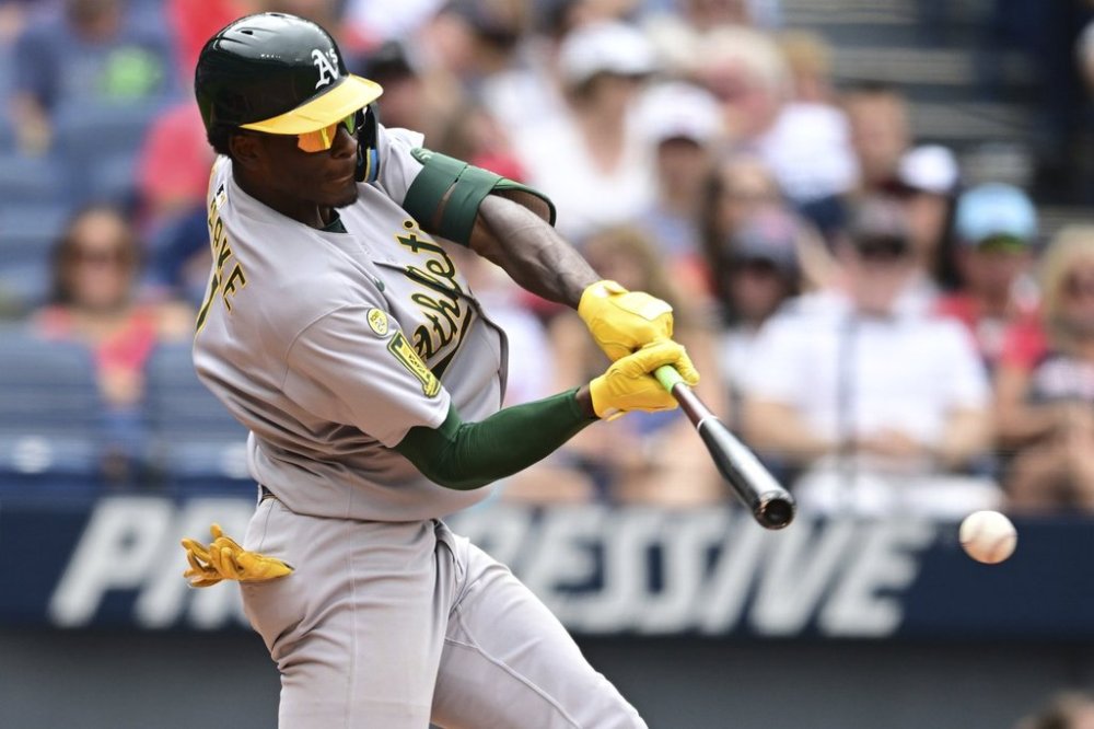 Athletics' Denzel Clarke hits a double during the eighth inning of a baseball game against the Cleveland Guardians, Sunday, July 20, 2025, in Cleveland. (AP Photo/David Dermer)