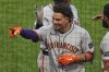 San Francisco Giants' Willy Adames points to the stands as he returns to the dugout after hitting a two-run home run off Pittsburgh Pirates pitcher Mike Burrows during the fifth inning of a baseball game in Pittsburgh, Tuesday, Aug. 5, 2025. (AP Photo/Gene J. Puskar)