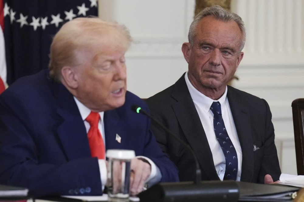 FILE - President Donald Trump, left, speaks as Health and Human Services Secretary Robert F. Kennedy Jr. listens during a Make America Healthy Again (MAHA) Commission Event in the East Room of the White House, Thursday, May 22, 2025, in Washington. (AP Photo/Jacquelyn Martin, File)