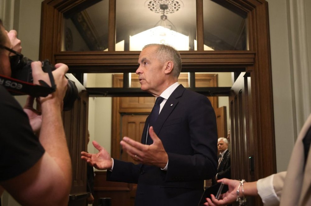 Prime Minister Mark Carney speaks to reporters as he arrives on Parliament Hill in Ottawa, on Monday, Aug. 18, 2025. THE CANADIAN PRESS/Patrick Doyle