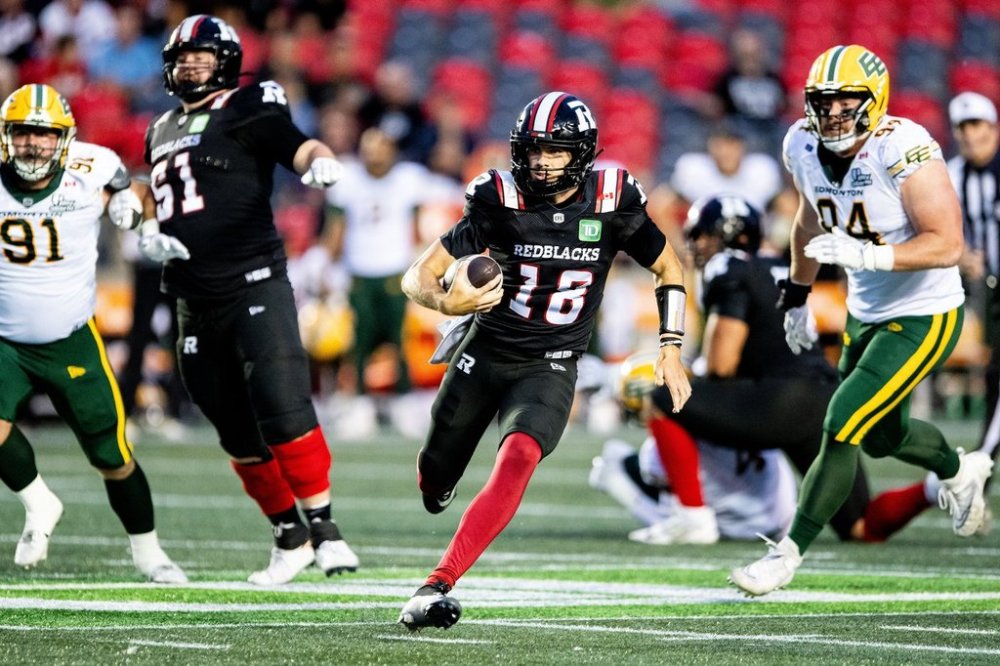 Redblacks quarterback Dustin Crum (18) runs with the ball during first-half CFL action against the Edmonton Elks in Ottawa on Friday, Aug. 22, 2025. THE CANADIAN PRESS/Spencer Colby