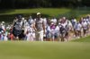 Scottie Scheffler and his caddie walk on the first fairway during the final round of the St. Jude Championship golf tournament Sunday, Aug. 10, 2025, in Memphis, Tenn. (AP Photo/George Walker IV)
