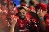 Cincinnati Reds' Jose Trevino is congratulated by teammates in the dugout after scoring on sacrifice by TJ Friedl during the ninth inning of a baseball game against the Los Angeles Angels, Tuesday, Aug. 19, 2025, in Anaheim, Calif. (AP Photo/Mark J. Terrill)