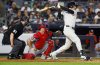 New York Yankees' Cody Bellinger, right, hits a single during the third inning of a baseball game against the Washington Nationals, Monday, Aug. 25, 2025, in New York. (AP Photo/Noah K. Murray)