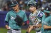 Seattle Mariners pitcher George Kirby, left, gets a visit from catcher Cal Raleigh, center, and pitching coach Pete Woodworth during the second inning of the Little League Classic baseball game at Bowman Field in Williamsport, Pa., Sunday, Aug. 17, 2025. (AP Photo/Gene J. Puskar)