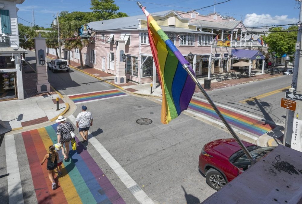 A family crosses one of four rainbow crosswalks on Duval Street in Key West, Fla., Tuesday, Aug. 26, 2025. (Rob O'Neal/The Key West Citizen via AP)