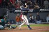 Cleveland Guardians' Steven Kwan, right, watches his winning sacrifice fly off Seattle Mariners' Andres Munoz as Mariners catcher Cal Raleigh, left, looks on during the ninth inning of a baseball game, Friday, Aug. 29, 2025, in Cleveland. (AP Photo/Phil Long)