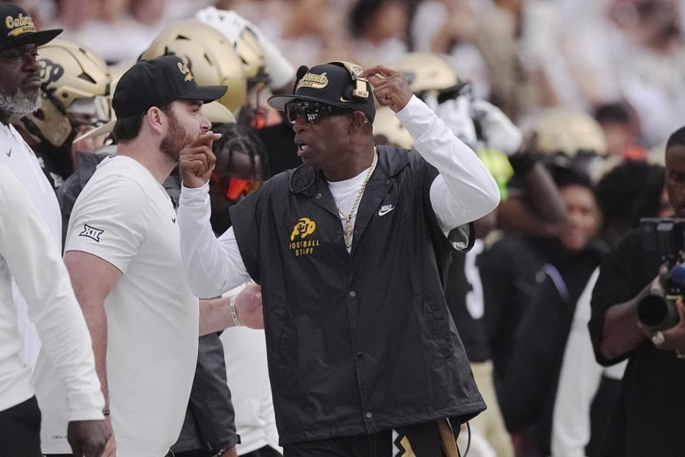 Colorado head coach Deion Sanders, center, exhorts his team in the first half of an NCAA college football game against Georgia Tech Friday, Aug. 29, 2025, in Boulder, Colo. (AP Photo/David Zalubowski)