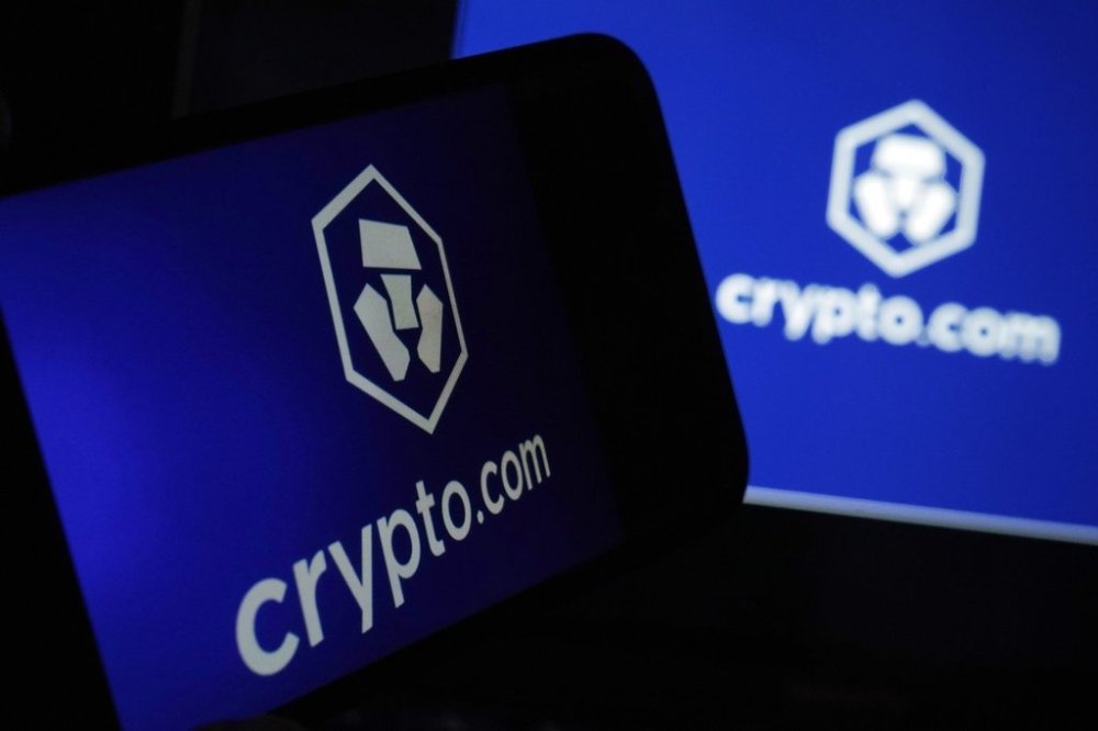 FILE - The logo for crypto.com appears on a mobile phone and computer screen, in New York, Jan. 31, 2023. (AP Photo/Richard Drew, file)