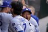 Los Angeles Dodgers manager Dave Roberts, right, fires up Shohei Ohtani prior to a baseball game against the Los Angeles Angels, Tuesday, Aug. 12, 2025, in Anaheim, Calif. (AP Photo/Mark J. Terrill)