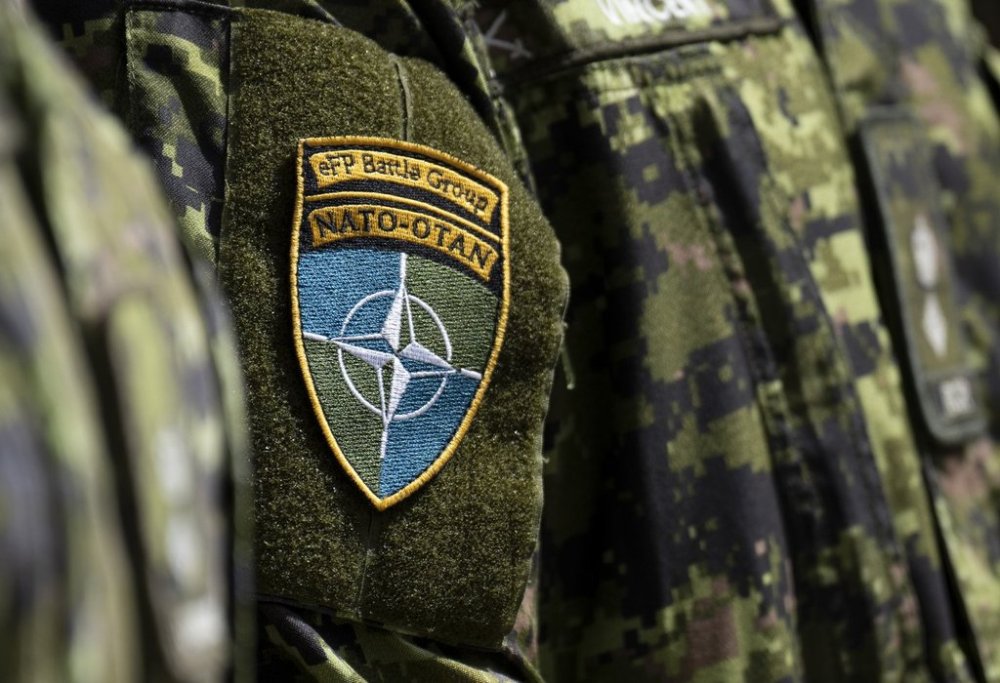 A Canadian soldier wears the NATO Battle Group patch as he listens to a speech at the military base in Adazi, Latvia, Monday, July 10, 2023. THE CANADIAN PRESS/Adrian Wyld