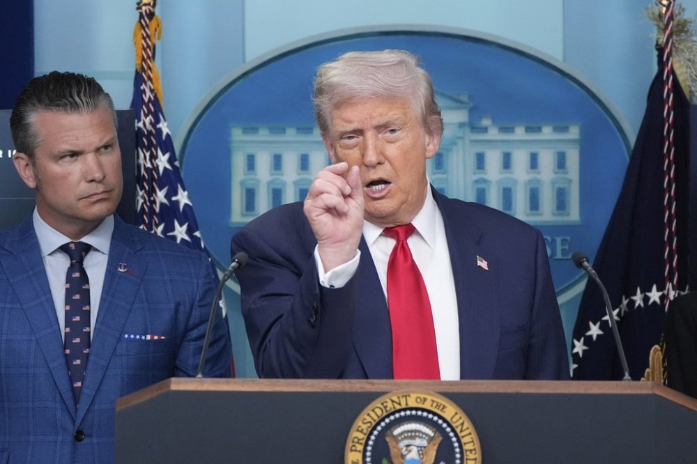 President Donald Trump speaks with reporters in the James Brady Press Briefing Room at the White House, Monday, Aug. 11, 2025, in Washington, as Secretary of Defense Pete Hegseth looks on. (AP Photo/Alex Brandon)
