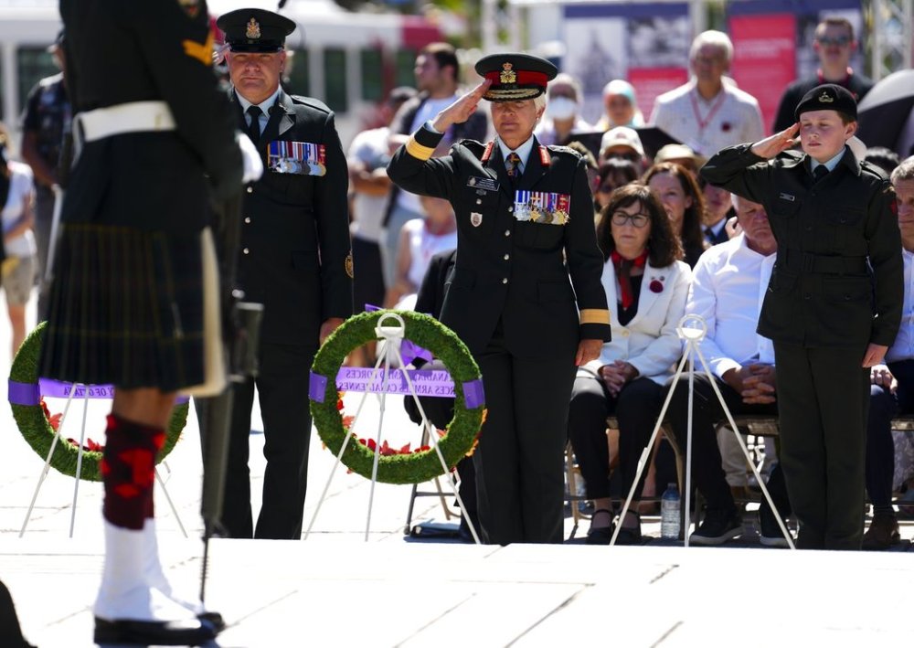 Chief of the Defence Staff Jennie Carignan, centre, salutes after placing a wreath during a ceremony to mark the 80th anniversary of the Victory of the Pacific and the end of the Second World War at the National War Memorial in Ottawa on Friday, Aug. 15, 2025. THE CANADIAN PRESS/Sean Kilpatrick