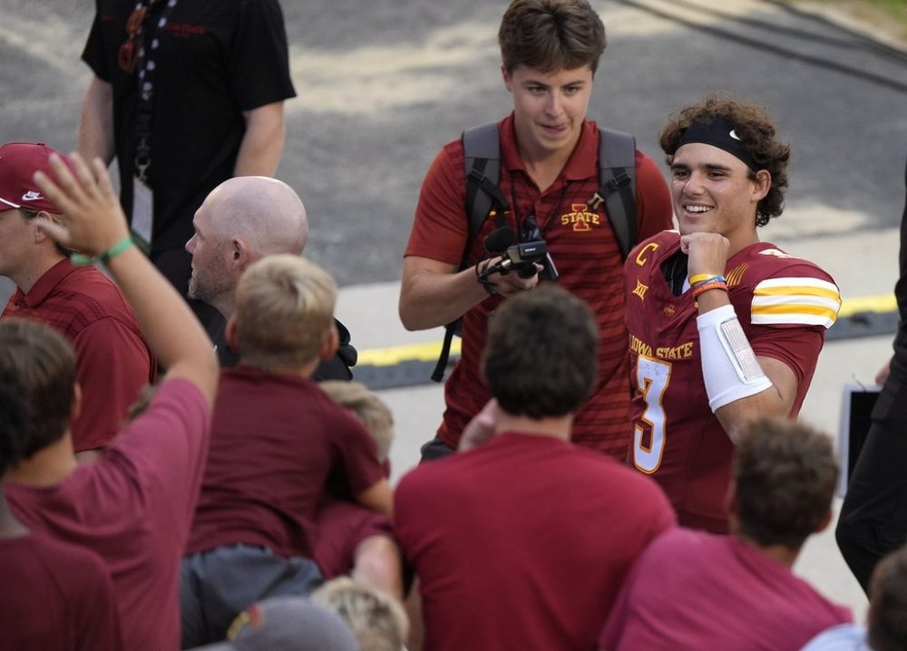 Iowa State quarterback Rocco Becht (3) celebrates the 55-7 win over South Dakota with fans after an NCAA college football game, Saturday, Aug. 30, 2025, in Ames, Iowa. (AP Photo/Matthew Putney)